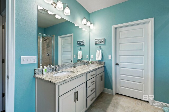 bathroom featuring an enclosed shower, vanity, and tile patterned floors