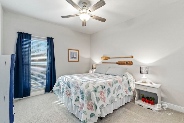 bedroom with ceiling fan and light colored carpet