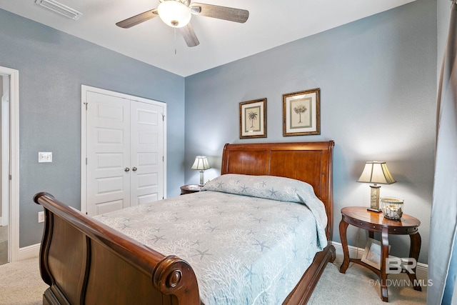 carpeted bedroom featuring a closet and ceiling fan