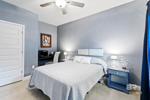 bedroom featuring ceiling fan and light carpet