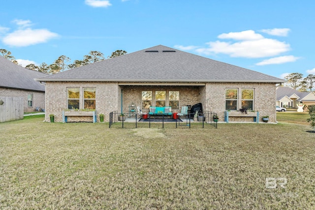 rear view of property featuring a yard and an outdoor hangout area