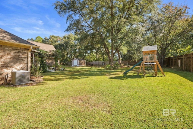 4331 Hamilton Oaks Ln, Mobile, AL 36695 - view of yard with central AC, a shed, a playground, and an outbuilding