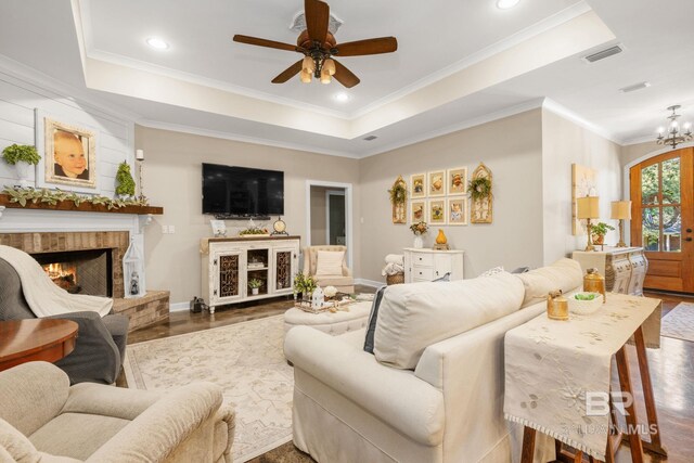 4331 Hamilton Oaks Ln, Mobile, AL 36695 - living area featuring a lit fireplace, ceiling fan, a tray ceiling, baseboards, and ornamental molding