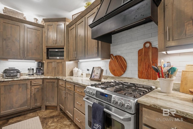4331 Hamilton Oaks Ln, Mobile, AL 36695 - kitchen featuring stainless steel appliances, under cabinet range hood, decorative backsplash, and light stone countertops