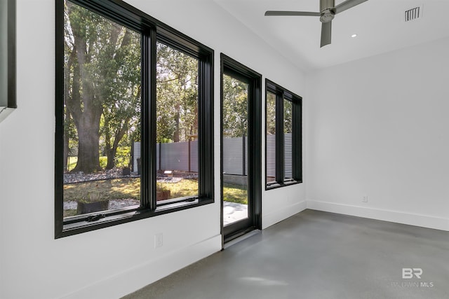 spare room featuring ceiling fan and a wealth of natural light