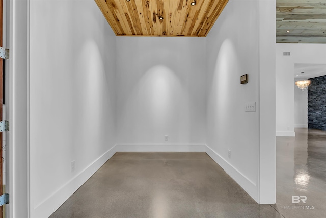 spare room with an inviting chandelier and wooden ceiling