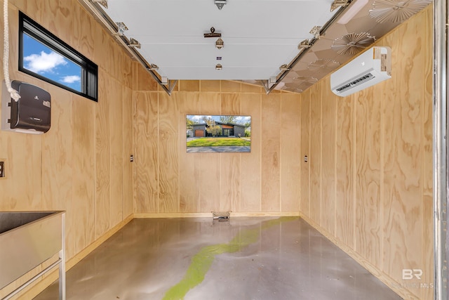 basement featuring wooden walls and a wall unit AC