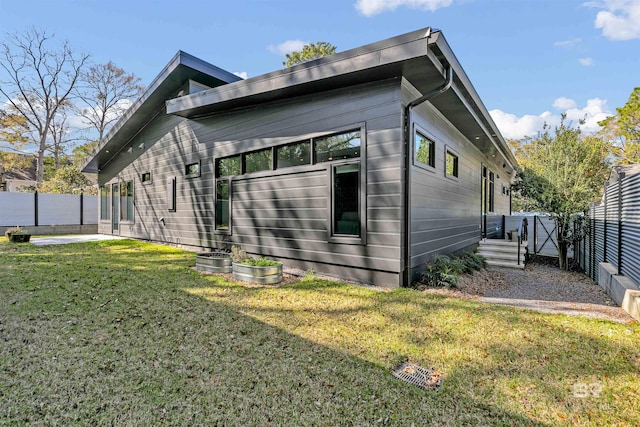 view of home's exterior with a yard