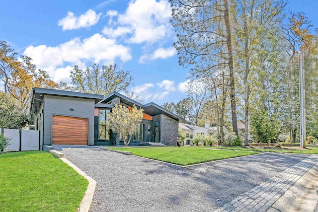 modern home featuring a front yard and a garage