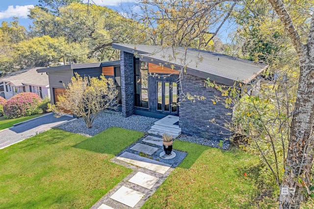 exterior space featuring a front lawn and french doors