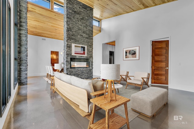 living room with wooden ceiling, a towering ceiling, and a fireplace