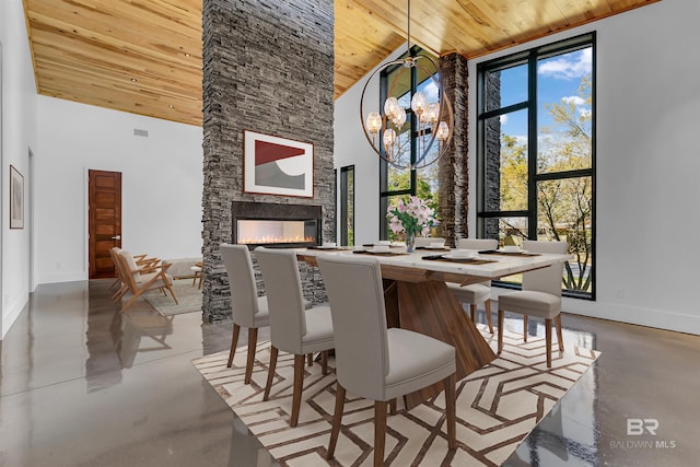 dining room featuring high vaulted ceiling, a fireplace, wood ceiling, and a chandelier