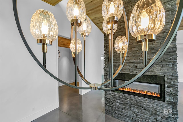 details featuring a stone fireplace and wooden ceiling