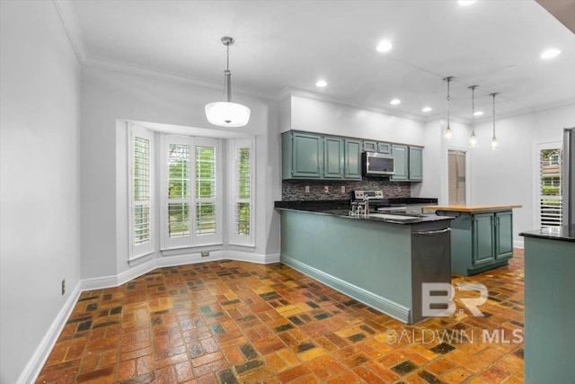 6505 Charing Wood Dr, Mobile, AL 36695 - kitchen with appliances with stainless steel finishes, ornamental molding, a peninsula, green cabinets, and dark countertops