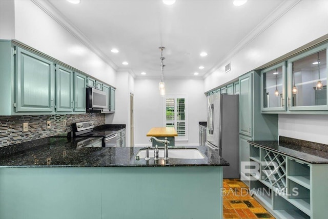 6505 Charing Wood Dr, Mobile, AL 36695 - kitchen featuring stainless steel appliances, dark stone countertops, ornamental molding, decorative backsplash, and a peninsula