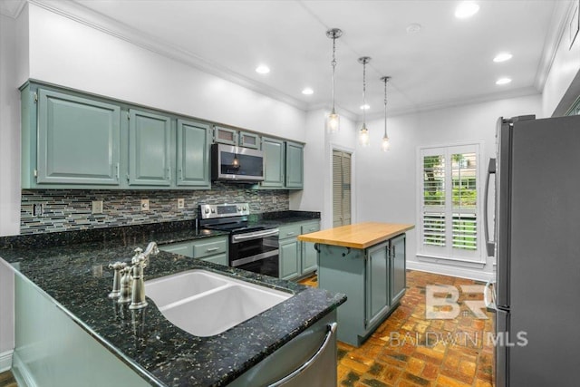6505 Charing Wood Dr, Mobile, AL 36695 - kitchen with appliances with stainless steel finishes, brick floors, backsplash, ornamental molding, and a center island