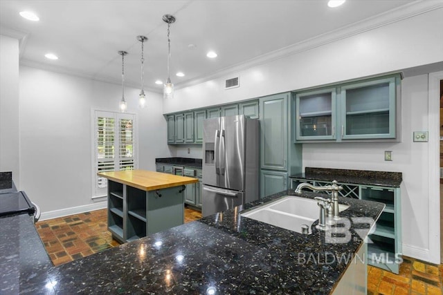 6505 Charing Wood Dr, Mobile, AL 36695 - kitchen featuring stainless steel fridge with ice dispenser, butcher block counters, a center island, crown molding, and open shelves