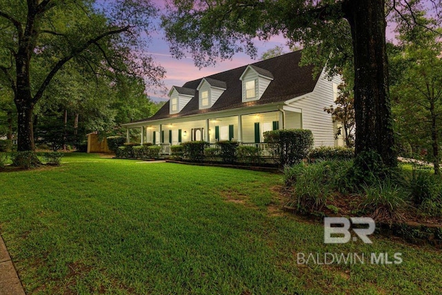 6505 Charing Wood Dr, Mobile, AL 36695 - cape cod house featuring covered porch and a lawn
