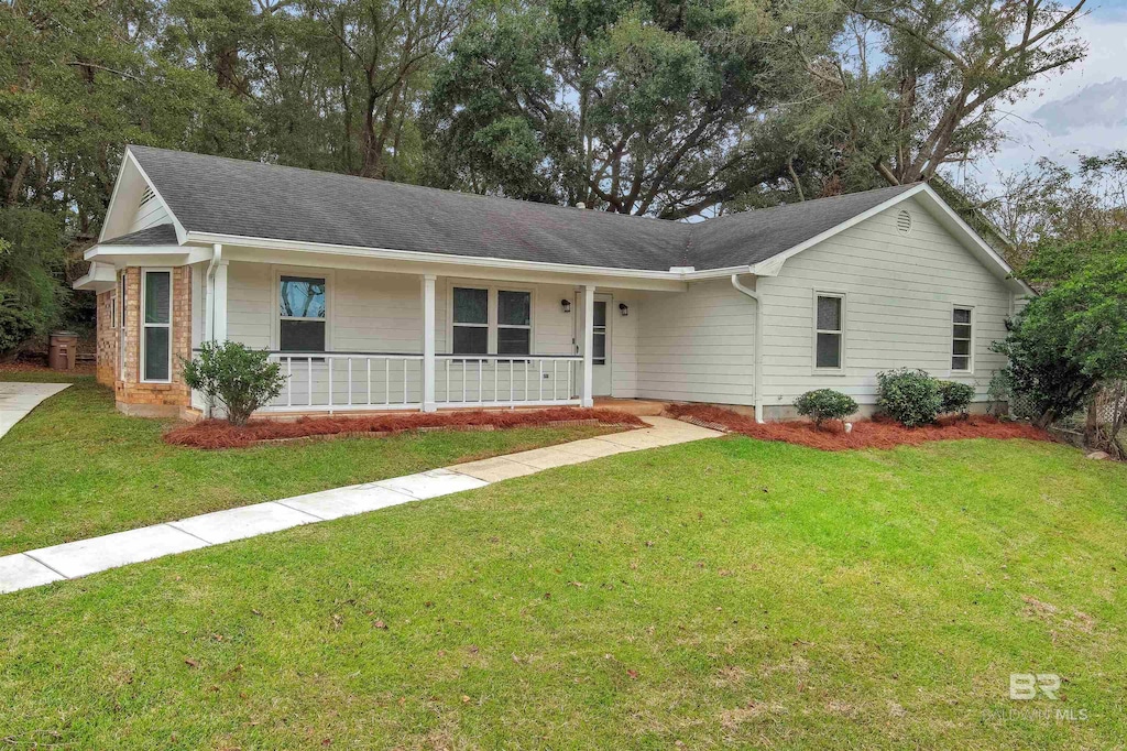 single story home with covered porch and a front yard