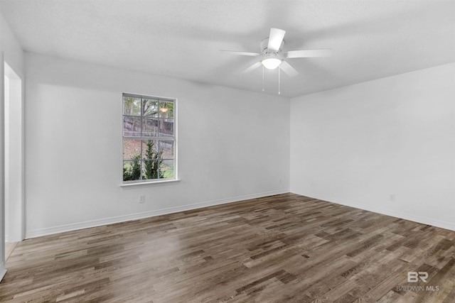 spare room featuring a textured ceiling, ceiling fan, and dark hardwood / wood-style floors