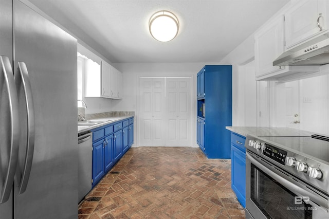 kitchen with blue cabinets, white cabinetry, sink, and appliances with stainless steel finishes