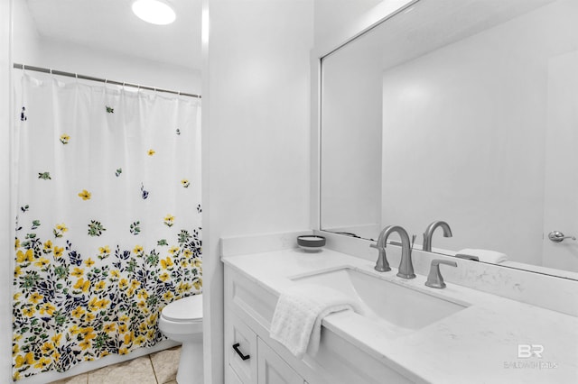 bathroom with tile patterned floors, vanity, and toilet