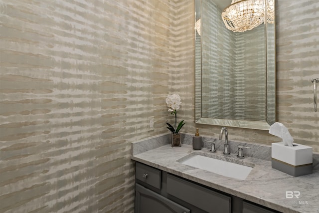 bathroom with vanity and an inviting chandelier