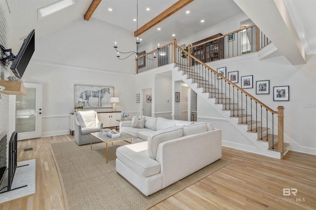 living area with recessed lighting, stairway, wood finished floors, beam ceiling, and high vaulted ceiling