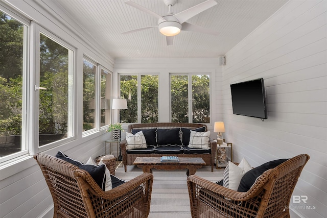 sunroom with outdoor lounge area and a ceiling fan