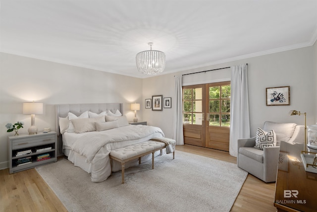 bedroom with access to outside, wood finished floors, crown molding, and a notable chandelier