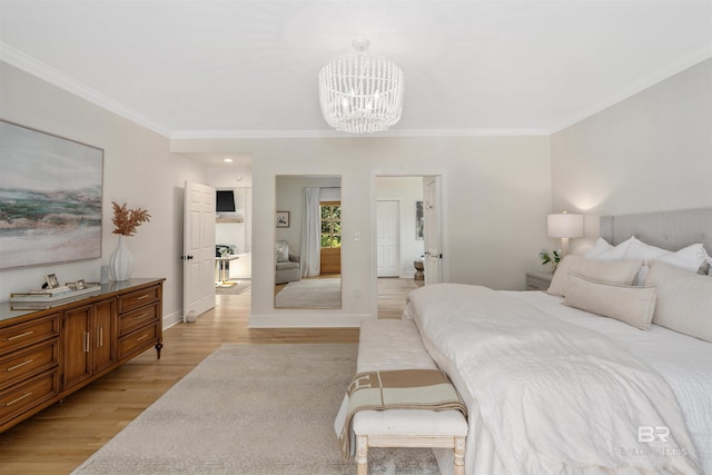 bedroom featuring a notable chandelier, baseboards, ornamental molding, and light wood-style floors