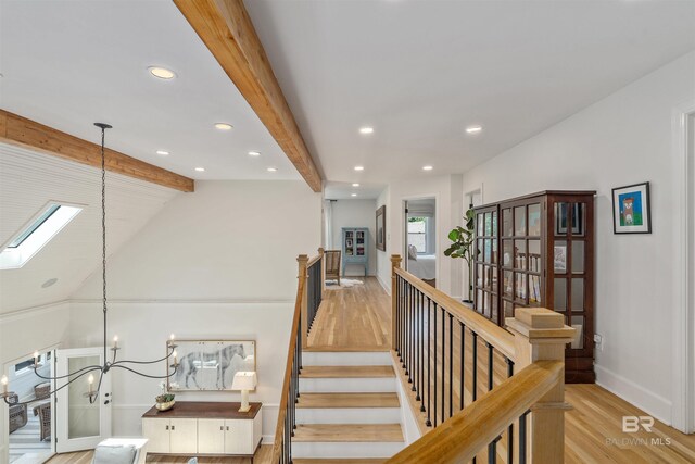 interior space with lofted ceiling with beams, baseboards, recessed lighting, a chandelier, and wood finished floors