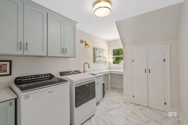 laundry room featuring cabinet space, marble finish floor, separate washer and dryer, and a sink