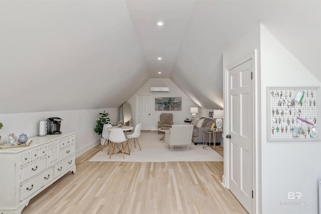 interior space featuring lofted ceiling, baseboards, light wood finished floors, and recessed lighting