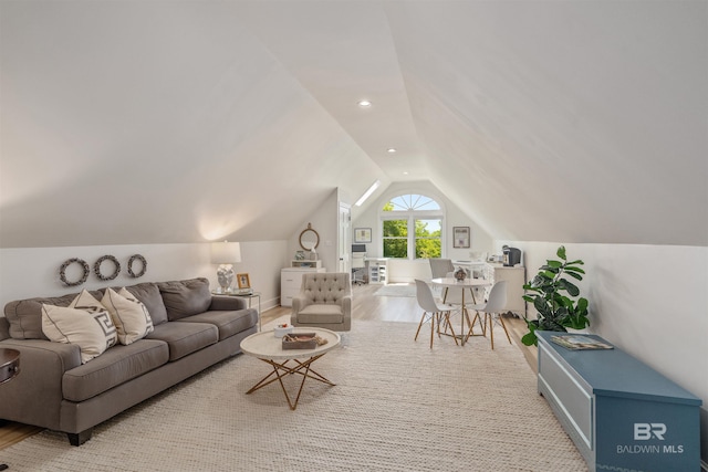 living room featuring lofted ceiling and wood finished floors