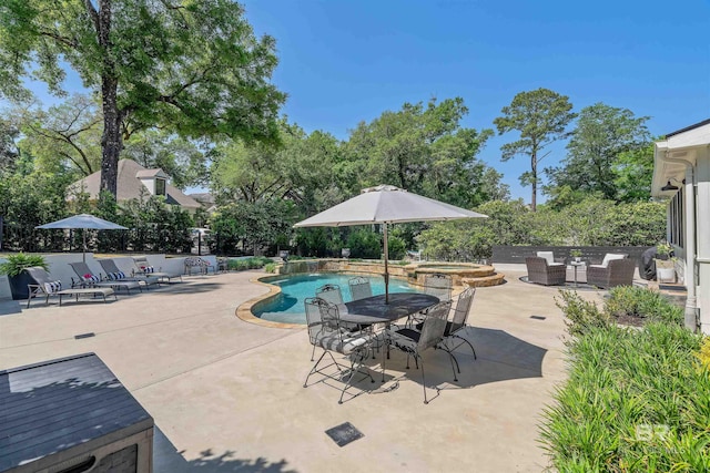 view of swimming pool featuring a patio area, outdoor dining space, and a pool with connected hot tub