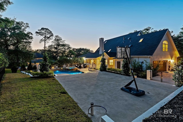 exterior space featuring a pool with connected hot tub and fence