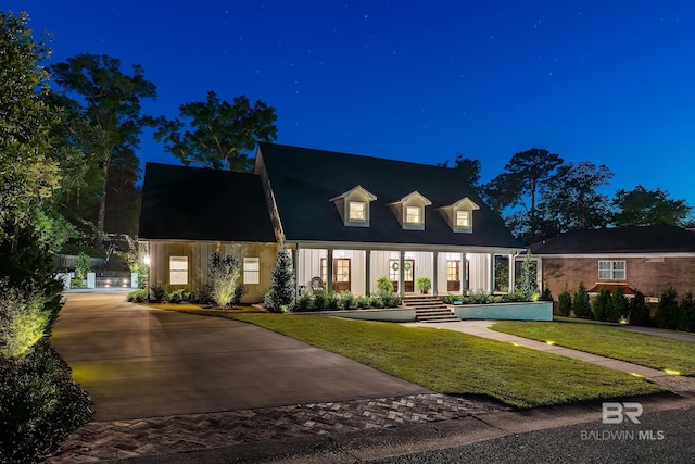 new england style home with a lawn