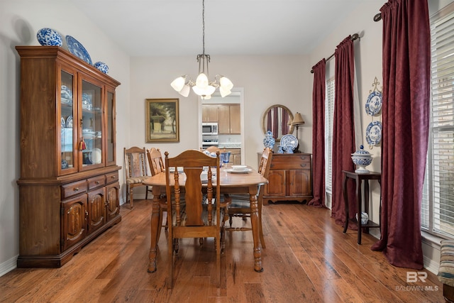 dining area with a chandelier and wood-type flooring