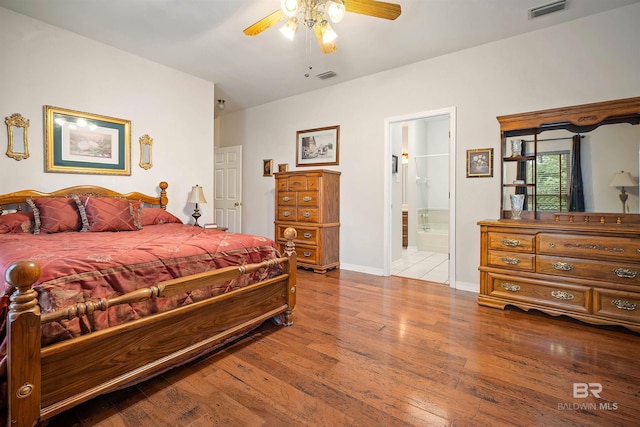 bedroom with ensuite bathroom, ceiling fan, and light wood-type flooring