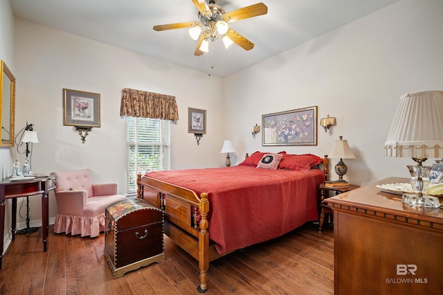 bedroom with dark hardwood / wood-style floors and ceiling fan