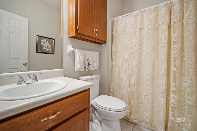 bathroom with tile patterned floors, vanity, and toilet