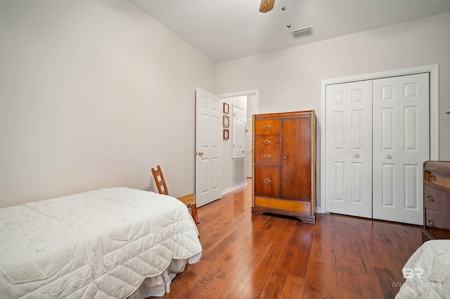 bedroom featuring ceiling fan, a closet, and dark wood-type flooring