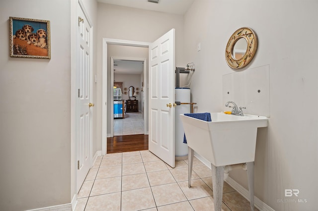 bathroom featuring tile patterned flooring and water heater