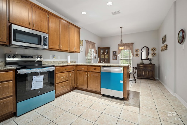 kitchen featuring light tile patterned flooring, appliances with stainless steel finishes, decorative light fixtures, and sink