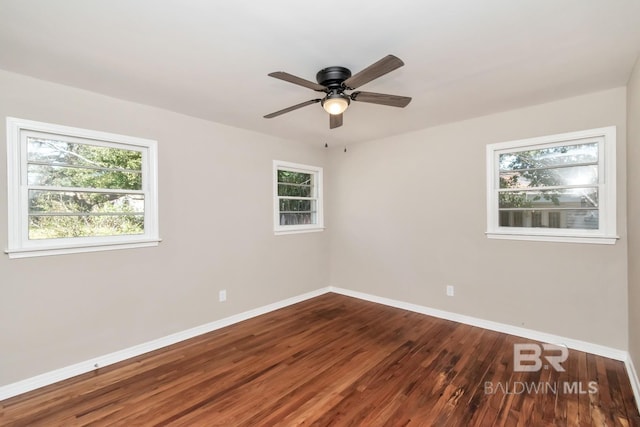 unfurnished room featuring wood finished floors, a ceiling fan, and baseboards