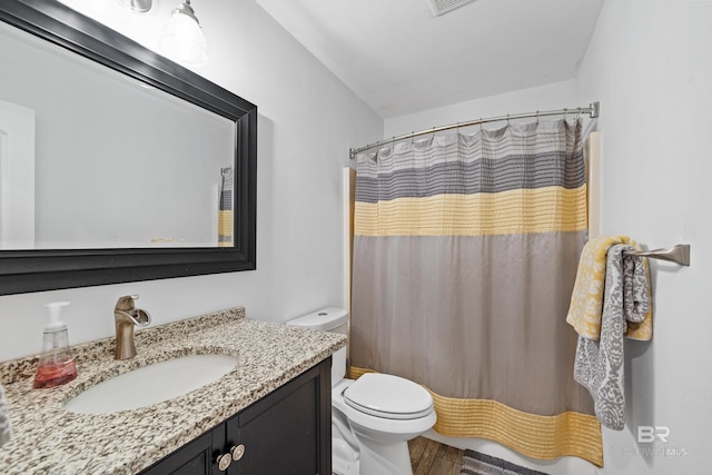 bathroom featuring toilet, vanity, hardwood / wood-style floors, and a shower with curtain