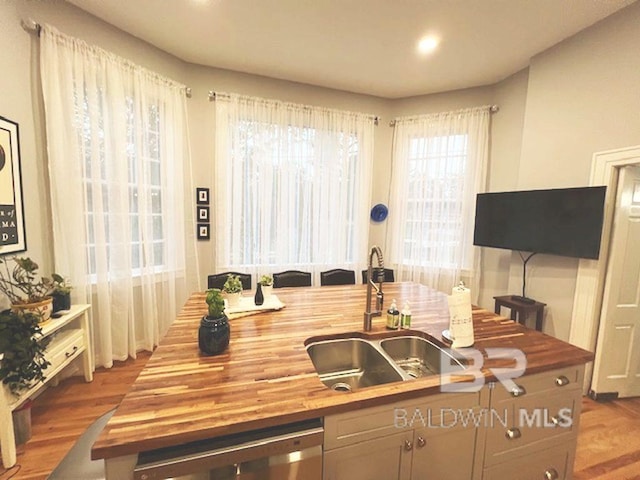 kitchen with wooden counters, light hardwood / wood-style floors, and sink