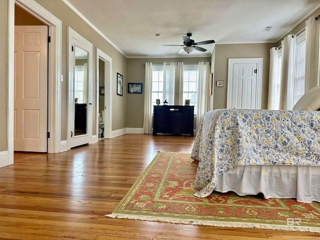 bedroom with ceiling fan, hardwood / wood-style floors, and crown molding