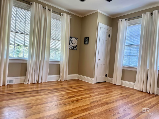 unfurnished room featuring ornamental molding and light hardwood / wood-style floors